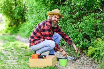 people in garden beds. Spring garden concept. Gardeners hands plant flowers in the backyard. Gardener planting flowers in dirt soil. Farmer planting seedling in organic garden. happy man