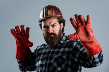 factory worker mechanic. industrial worker in helmet. man in gloves. construction worker in hard...