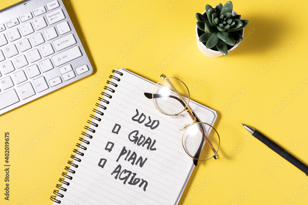 Poster a flat lay of a notepad with a motivational schedule written on it on yellow background