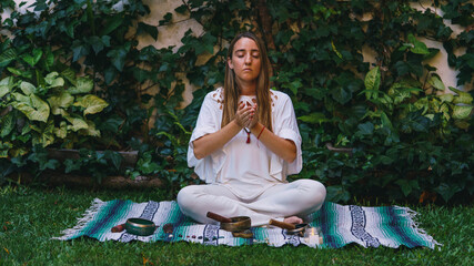 woman doing alternative medicine playing tibetan singing bowls that heals