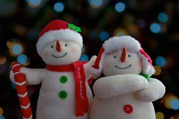 snowmen couple with lights background