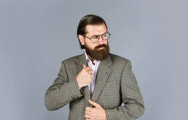 serious bearded man. handsome and successful man in expensive suit. He is in white shirt and glasses. stylish successful man in suit posing. business man wear suit. official office lifestyle