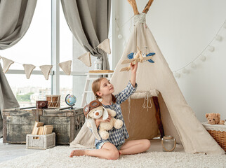 Happy little girl flying wooden plane © tan4ikk