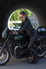 Fototapeta na wymiar woman in black with a motorcycle