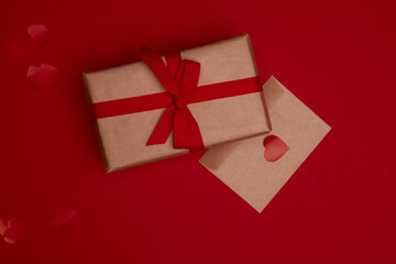 Valentine day composition with copy space. Present or gift box wraped in craft paper with ribbon...