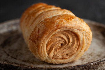 Baked sweet with condensed milk on a plate.
