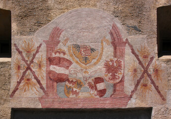 Unfinished renaissance fresco painting work with coat of arms at the Tauferer Tor city gate in the old town of Glurns in Vinschgau region, South Tyrol in Italy