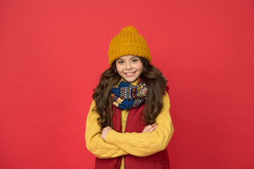 cheerful girl ready for winter activity. teen child in puffer waistcoat and knitwear. seasonal kid...