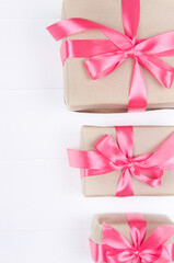 Gift boxes with bow on white wooden background. Valentine's Day, Mother's Day, March 8, World Women's Day holiday concept.