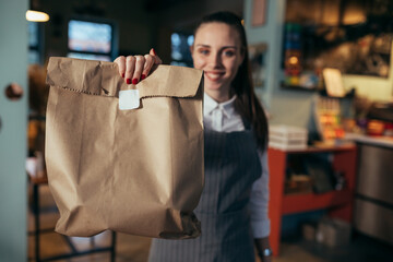waitress holding prepared takeaway food in eatery. food delivery concept. coronavirus quarantine...
