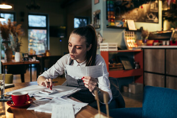 woman entrepreneur dealing with financial in her restaurant