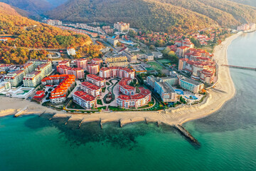 Bulgaria, no tourists, empty beach. Black Sea cost in low season. Hotel buildings, mountains,...