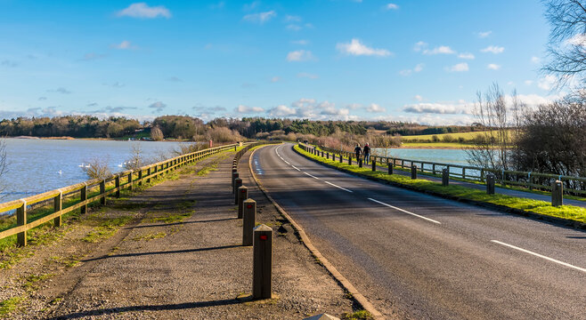 A view along the causeway across Pitsford Reservoir, UK on a sunny day