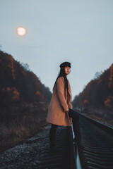 woman walking on a railroad
