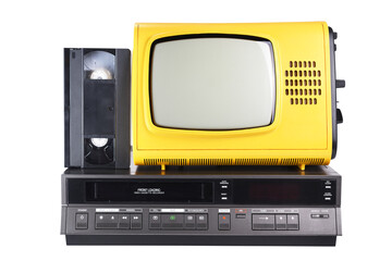 Old yellow vintage TV with videotape stands on a VCR from the 1980s, 1990s, 2000s, isolated on a white background.