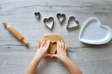 DIY making gingerbread by kid for Valentine's Day for parents. Baking training for children from 4 to 14 years old. early child development of fine motor skills. step by step. step 2