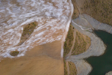 Drone aerial panorama of a desert like hill landscape with marble stones dust at sunset in Terena, Portugal