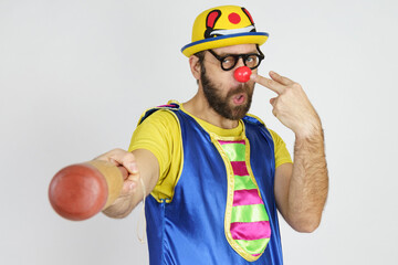 The clown is a man in a bright blue and yellow suit with a baseball bat.