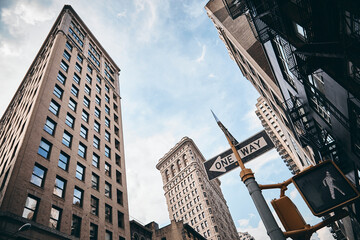 A low angle shot of the Flatiron building in Manhattan, New York against the cloudy sky