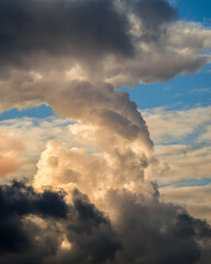 Fototapeta na wymiar Bizarre dark cloud like mushroom in blue sky