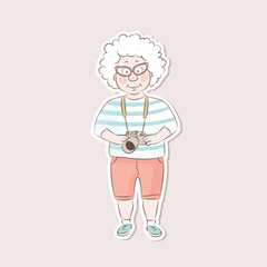 Sticker nice old woman with a camera.Cute old lady traveling.Vector illustration in a cartoon style.