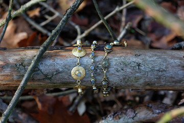 Three brass bracelets with labradorite stone on wooden background