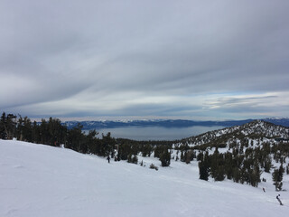 Fototapeta na wymiar Landscape views of Lake Tahoe from a ski resort, on a cloudy winter day