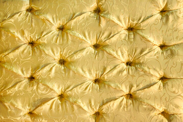 Full frame background of classic and luxury furniture or interior design - golden velvet sofa upholstery in the royal style