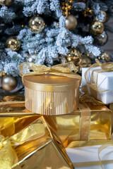 Golden gift under the Christmas tree. Many gifts under the tree.