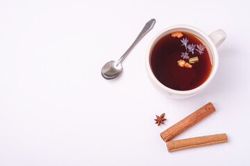 Fototapeta na wymiar Hot black aromatic tea, Christmas breakfast mood with anise and cinnamon on white background, top view