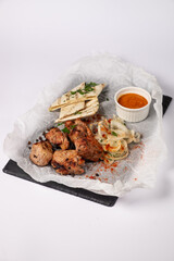 Pork Skewers, onions, pita bread, sweet chili sauce on a white background