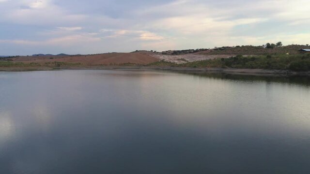 Drone aerial panorama of a desert like hill landscape with marble stones dust at sunset in Terena, Portugal