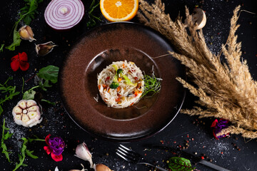 Basmati rice with fried carrots, onions, mushrooms, broccoli vegetables in butter on a dark background