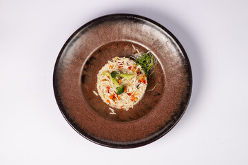 Basmati rice with fried carrots, onions, mushrooms, broccoli vegetables in butter on a white background