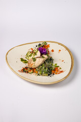 Grilled chicken fillet in the middle with mozzarella and tomatoes, on a pillow of green beans and spinach in cream on a white background