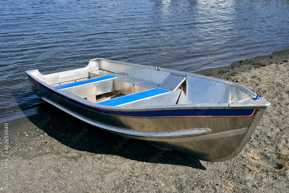 Wall mural aluminium boat on the beach