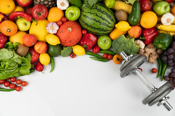 Fitness concept. Healthy nutrition: fruits and vegetables. Equipment for fitness exercises: weighing machine and dumbbells. 