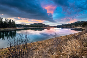 The Priest River seen under cloudy winter skies at sunset in the town of Newport, Washington USA.