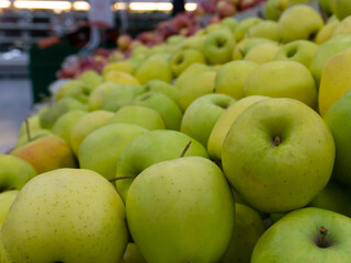 green apples in the supermarket, on the counter