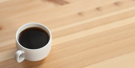 Cup of coffee on a wooden table. Breakfast morning