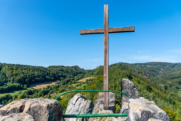 Wooden cross on the top rock
