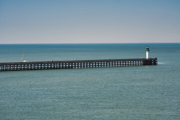 Pier with lighthouse, shoot from ferry at port of Calais, France