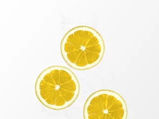 Foto op Plexiglas Lemon water Photo template with copy space Slices of juicy lemons dropped into water © Picture Store