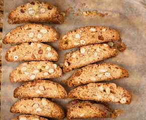 pieces of baked italian christmas biscotti cookies on a brown paper