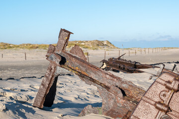 A sunny day with shipwrecks on a sandy beach in Norderney