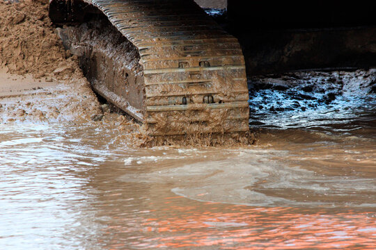 excavator tracks in the water. repair and expansion of a road in the north of gatchina, russia. reportage shooting.