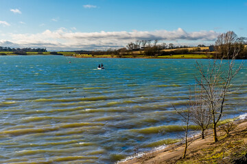 A view down Pitsford Reservoir, UK from the causeway on a sunny day