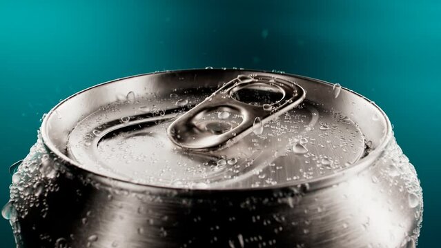 Opening up a  flip-top can of soda. Cool canned drink with droplets. Refreshment