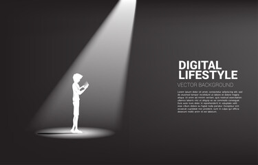 Silhouette of man use mobile phone in spot light. Concept for remote work with mobile.