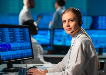 Diverse team of brokers workin in office using workstation and analysis technology. Workplace of professional traders. Global financial markets, business strategy, currency exchange and banking.